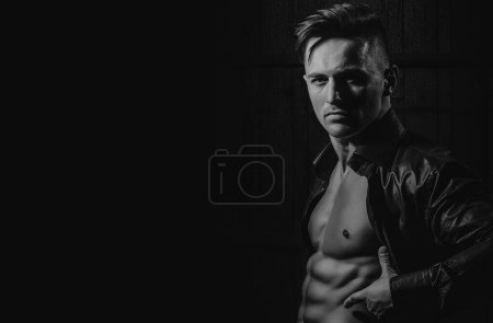 Photo for Sexy young handsome naked man on dark background. Seductive gay - Royalty Free Image