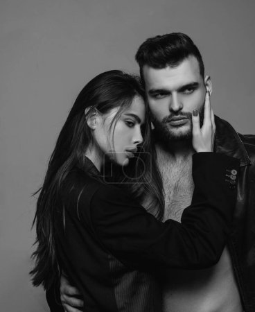 Photo for Man brutal well groomed macho and attractive feminine girl long hair cuddling. Girlfriend passionate red lips and man leather jacket. Passionate hug. Couple passionate people in love. Passion fashion. - Royalty Free Image