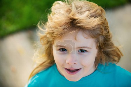 Photo for Adorable little girl boy closeup outdoors in summer. Kids face close up. Funny blonde little child close up portrait - Royalty Free Image