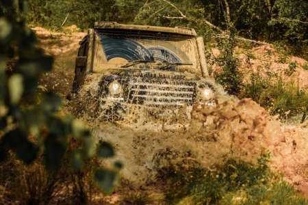 Photo for Off-road vehicle goes on the mountain. Mudding is off-roading through an area of wet mud or clay. Tracks on a muddy field. Track on mud. 4x4 Off-road suv car. Offroad car. Safari - Royalty Free Image