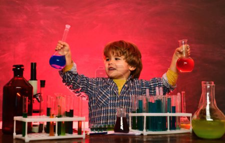 Photo for They carried out a new experiment in chemistry. Home schooling. Happy little scientist making experiment with test tube. Lab microscope and testing tubes. Preschooler - Royalty Free Image