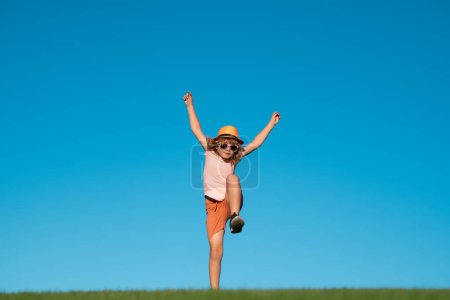 Photo for Kid boy running on green grass near blue sky in spring park. Child running outdoor. Healthy sport activity for children. Little boy at athletics competition race. Runner kids exercising - Royalty Free Image