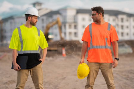 Photo for Two engineers. Architect at a construction site. Handyman builders in hardhat. Building concept. Builder foreman. Two hispanic men, construction workers in helmet at construction site - Royalty Free Image