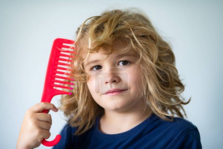Photo for Kids barber shop. Child with brush combing hair. Boy taking hairstyle. Child brushing hair with comb, kids haircare - Royalty Free Image