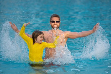 Photo for Kid splash water in pool. Father and son swimming and splashing in blue sea water. Family on summer holiday. Happy parents and children relaxing on beach. Dad and child playing in poolside - Royalty Free Image