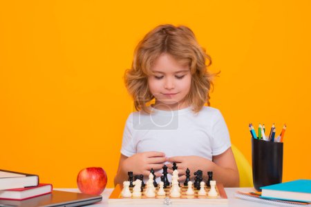 Photo for Child play chess on isolated background. Child think about chess game. Intelligent, smart and clever school kid pupil. Games for brain intelligence concept - Royalty Free Image