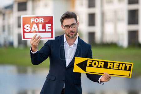 Photo for American house seller, real estate agents hold sign for sale and for rent. Real estate trading ideas and bank loans for buying and selling houses. Rent or sale - Royalty Free Image