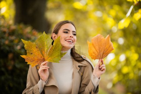 Photo for Autumn romance woman with leaves. Female model on foliage day. Dream and lifestyle. Beauty outdoor portrait. Carefree gorgeous sensual natural tender charming girl with leaf on face. Fall nature - Royalty Free Image