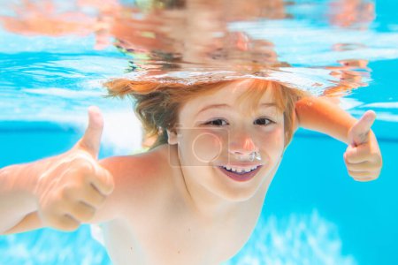 Photo for Child face underwater with thumbs up. Young boy swim and dive underwater. Under water portrait in swim pool. Child boy diving into a swimming pool. Active healthy lifestyle, swim water sport - Royalty Free Image