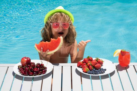 Photo for Healthy food. Outdoor leisure activity with kids by swimming pool. Summertime. Child in swimming pool. Kids swim on summer vacation. Beach sea and water fun. Summer kids cocktail and fruits - Royalty Free Image