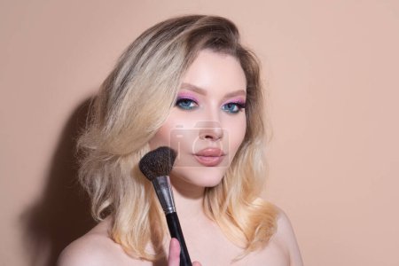 Photo for Beautiful young woman with makeup blusher brush. Facial treatment. Cosmetology, beauty and spa. Portrait of beauty model with make up on beauty face - Royalty Free Image