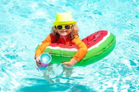 Téléchargez les photos : Summer swimming and relax, swim on ring in pool, poolside. Child in swimming pool. Summer activity. Healthy kids lifestyle - en image libre de droit
