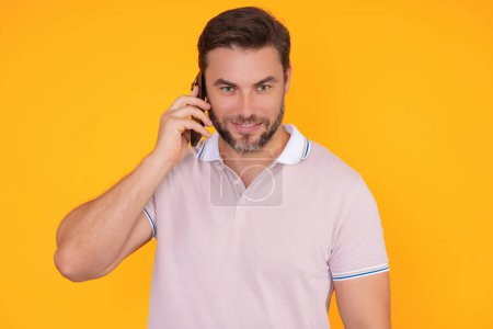 Photo for Portrait of a cheerful man using mobile phone isolated over studio background. Caucasian man using smart phone cellphone for calls, social media, mobile app. Online chatting. Guy talking on the phone - Royalty Free Image