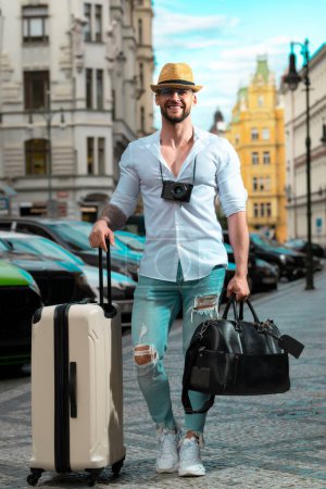 Foto de Travelling concept. Traveler tourist man in casual clothes with suitcase. Man travel abroad weekends. Journey concept - Imagen libre de derechos