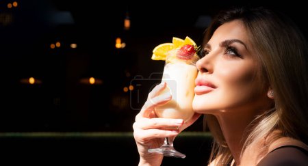 Photo for Close up photo of dreaming woman with sensual lips and mouth drinking cocktails. Cocktail menu. Cocktail for young. Bar and restaurant concept. Pina colada - Royalty Free Image