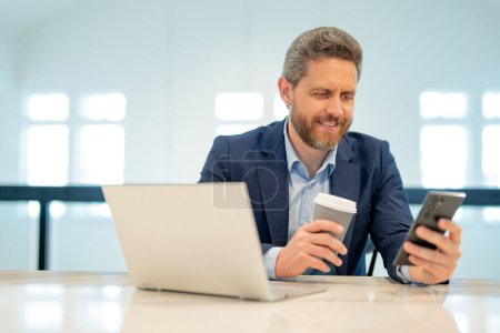 Photo for Manager, ceo talk on phone in suit in office. Office worker using phone, office call center. Man talk on phone. Business man have business call, talking on phone. Office interior - Royalty Free Image