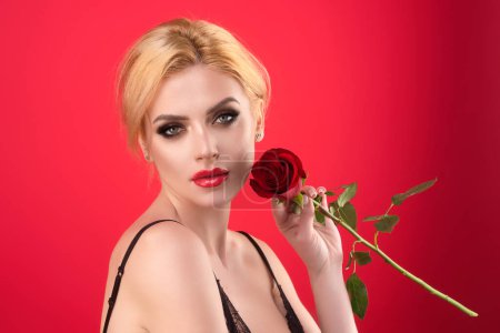 Foto de Love and dating. Beauty girl with red rose. Beautiful sensual woman hold flowers, studio portrait - Imagen libre de derechos