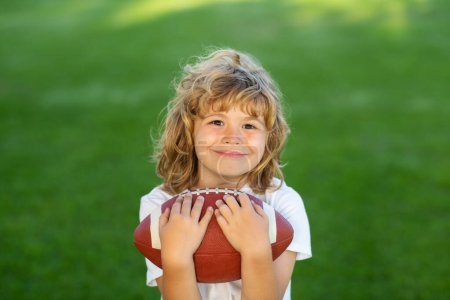 Photo for American style football. American football. Portrait of boy holding american football ball in park. - Royalty Free Image