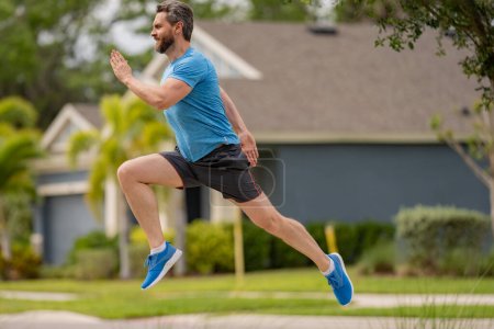 Photo for Sport runner. Man running. Fit male sport fitness model sprinting outdoors. Attractive man running fast, workout outdoors, runner jogging over american street - Royalty Free Image