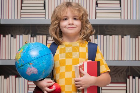 Photo for School boy with world globe and books. Back to school. Funny little child from elementary school with book. Education. Kid study and learning - Royalty Free Image