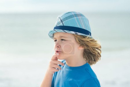 Photo for Little boy in summer sunglasses and hat on sea beach. Kid on summer vacation. Kids dreaming face. Outdoor closeup portrait of funny kids face. Summer kid outdoor portrait. Close up face of cute child - Royalty Free Image