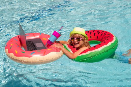 Photo for Summer office and freelance concept. Summer business. Kid remote working on laptop in pool. Little business man working online on laptop in summer swimming pool water - Royalty Free Image