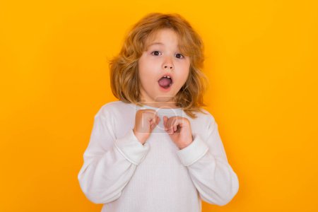 Photo for Excited child boy on studio isolated background. Surprised face, amazed emotions of kids - Royalty Free Image