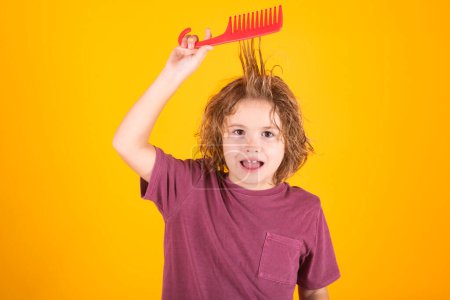 Photo for Child combing hair after shower. Little kid combing hair, isolated studio background - Royalty Free Image