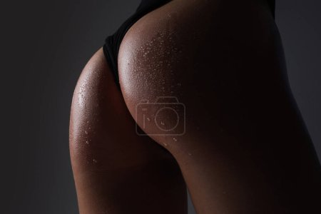 Photo for Sexy woman body stripper. Great ass. Sexy female wearing of pants. Sexual girl takes off bikini. Woman shows a beautiful ass, butt. Sext female body. Sexy buttocks in erotic lingerie. Thong bikini - Royalty Free Image
