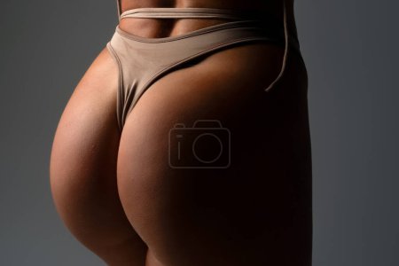 Photo for Sexy female ass in black panties. Female with sexy butt. Sexy curves girl buttocks without cellulite. Beautiful female butt. Panties off, bikini down undress lingerie undressing thong panties concept - Royalty Free Image