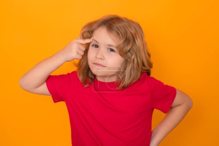 Photo for Serious kid thinking on studio isolated background. Think and idea. Thoughtful kid studio portrait. Doubt and concerned kids expression - Royalty Free Image