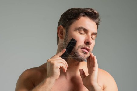 Photo for Caucasian man trying to make a beard hair cut by himself with scissors. Male haircut. Barber scissors, barber shop. Barber scissors. Cutting hair concept. Mens hair style and hair cut - Royalty Free Image