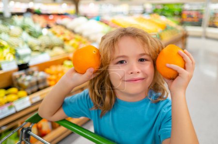 Photo for Child with shopping basket full of vegetables and fruits. Kid in a food store. Supermarket shopping and grocery shop concept. Child with shopping basket - Royalty Free Image