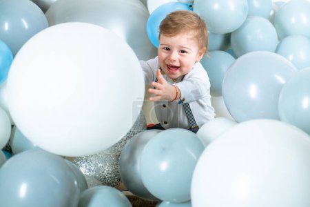 Photo for Baby hugging balloons. Kid funny face air balloons. Blue balloons, birthday decoration for children. Dreamy kids face. Daydreamer child portrait close up. Dreams and imagination. Dreamy baby face - Royalty Free Image