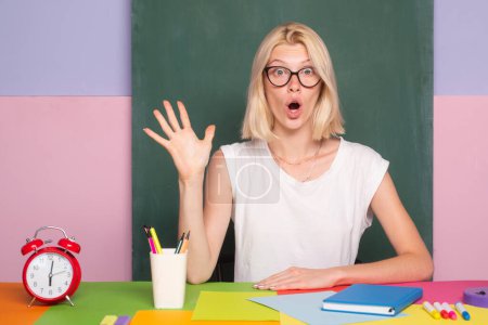 Photo for Excited school teacher in class on blackboard background. Professional portrait - Royalty Free Image