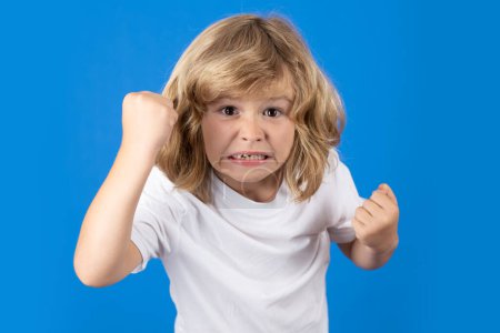 Photo for Child with angry expression in studio. Angry hateful little boy, child furious. Angry rage kids face. Anger child with furious negative emotion portrait. Aggressive and mad kid angry behavior - Royalty Free Image