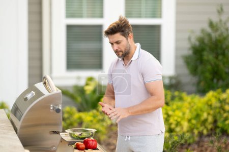 Photo for Grill chef cook. Guy with BBQ cooking tools. Barbecue and grill. Picnic and barbecue party. Chief cook with utensils for barbecue grill. Barbeque on holiday picnic. Man grilling a steak on BBQ - Royalty Free Image