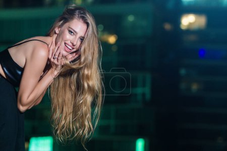 Photo for Sexy girl in fashion style on night city background. Sexy girl posing on night city street. Portrait of sensual girl against night city. Nightlife and urban atmosphere. Night downtown street - Royalty Free Image