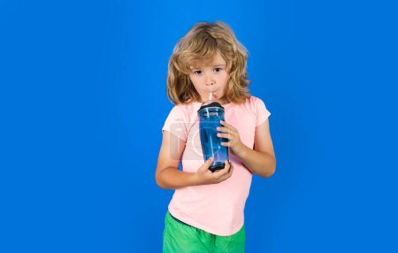 Photo for Kid drinking water, isolated on studio background. Cute blonde child boy enjoy pure fresh mineral water. Thirsty kid hold glass aqua water. Healthy water to refreshment - Royalty Free Image
