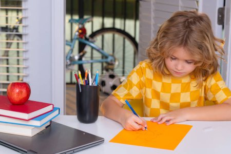 Photo for School child writing school homework. Kid boy from elementary school doing homework at home. Pupil go study. Clever schoolboy learning. Kids study, knowledge and education - Royalty Free Image