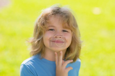 Photo for Kids dreaming face. Lifestyle closeup portrait of funny kids face outdoors. Summer kid outdoor portrait. Close up face of cute child. Kid having fun outdoor on sunny summer day - Royalty Free Image
