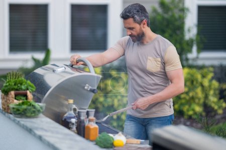 Photo for BBQ, grilling, barbecue outside. Man with barbeque roast fish outdoor. Grilling and barbecue concept. Bbq and grill. Man in barbecue preparing fish salmon. Chef cooking barbecuing seafood - Royalty Free Image