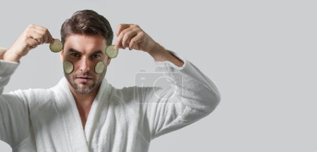 Photo for Clean face, face care, facials concept. Middle aged man with cucumber mask isolated on studio background. Cucumber for cosmetics skin mask. Facial mask with cucumber. Spa, dermatology. Banner - Royalty Free Image