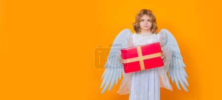 Photo for Angel child hold gift present. Angel child. Isolated studio shot. Cute kid with angel wings. Cupid, valentines day concept - Royalty Free Image