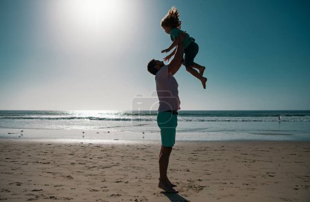Photo for Father throws son up against the blue sky. Dad throwing child. Handsome man father carrying young boy son. Happy dad holding child. Lifestyle and family vacation, happiness men concept - Royalty Free Image