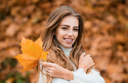 Photo for Autumn beauty and fashion. Woman fashion wodel with fall maple leaf outdoors - Royalty Free Image