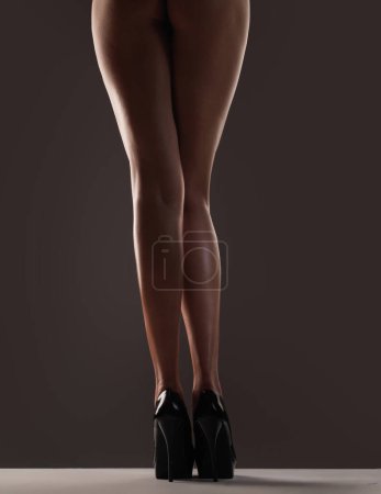 Photo for Isolated female legs in high heels. Shoes and fashion. Beautiful sexy slim legs woman with a heels shoes. Studio shoot of woman legs in high heel shoes. Fashion stiletto, high heels sandals - Royalty Free Image