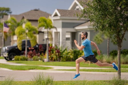 Photo for Fit man fitness model workout outdoor. Man runner on the street running for exercise. Man running in at spring morning. Running man. Male runner jogging. Guy training outdoors. Sport, cardio concept - Royalty Free Image