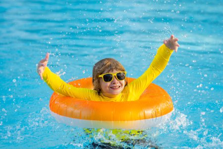 Photo for Summertime fun. Little kid swimming in pool. Kid in swimming pool. Kid relax swim on inflatable ring. Summer vacation concept - Royalty Free Image