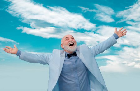 Photo for Carefree life winner old mature man. Vintage success male in white suit having fun on sky background - Royalty Free Image